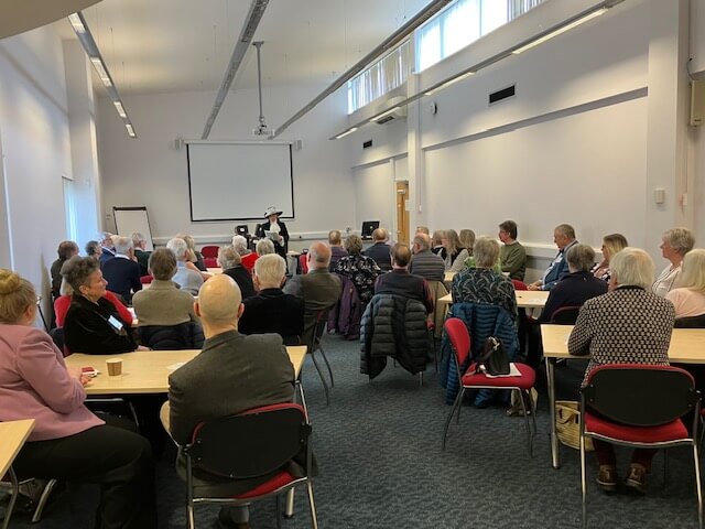 Room filled with people attending a speech by speaker High Sheriff Selena Graham