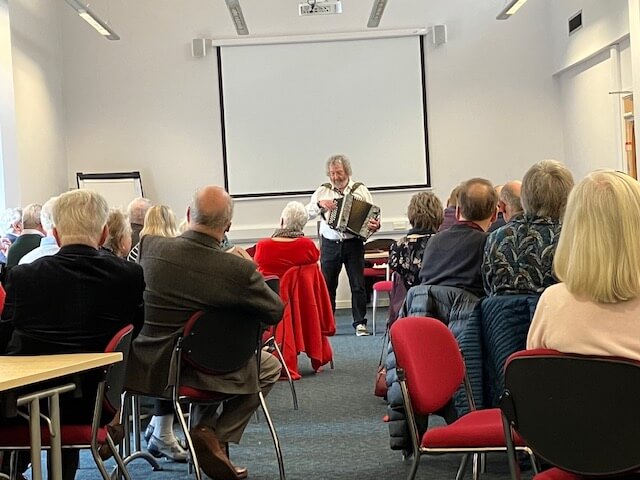 Ray and Bevington performing folk music and song to an audience
